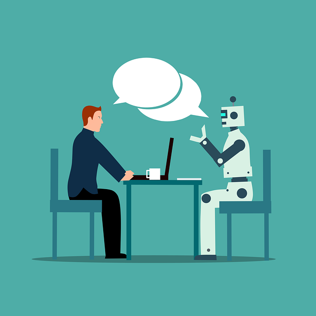 rozhovor-ai-clovek-stul-pocitac-zidle-robot